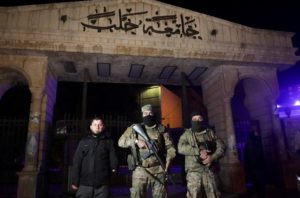 Syrian opposition fighters stand in front of University of Aleppo, after rebels opposed to President Bashar al-Assad said ...