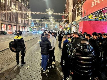 Israeli football supporters are guarded by police after violence targeting Israeli football fans broke out in Amsterdam ov...