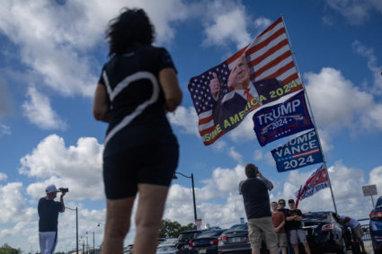 People take pictures of flags outside of U.S. President-elect Donald Trump's residence at Mar-a-Lago in Palm Beach, Florida,