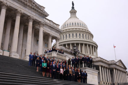 Newly-elected members of Congress pose for photos at the Capitol building in Washington