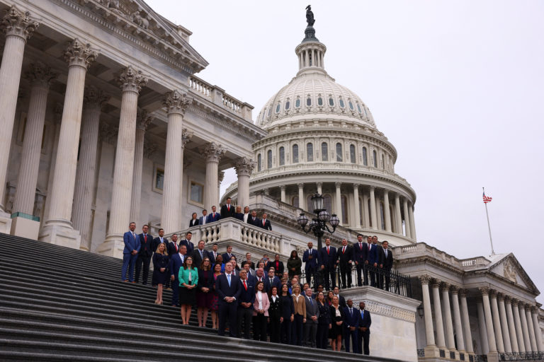 Newly-elected members of Congress pose for photos at the Capitol building in Washington