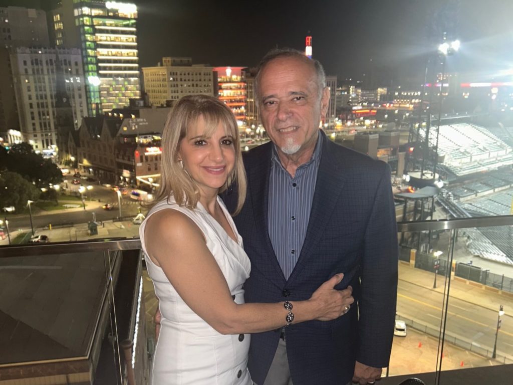 Hassane and Siham Awada Jaafer stand together in front of a city lit up at night