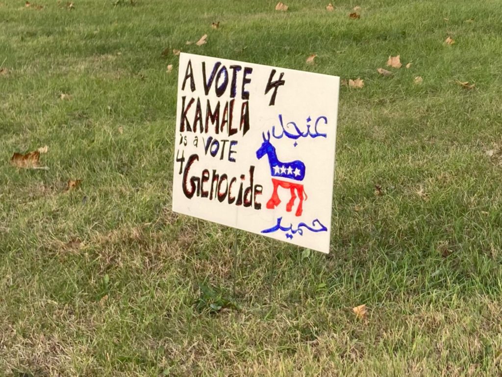 A lawn sign in Dearborn, Michigan, reads, “A vote 4 Kamala is a vote 4 genocide” with a picture of the Democratic donkey. Photo by Frances Kai-Hwa Wang/PBS News