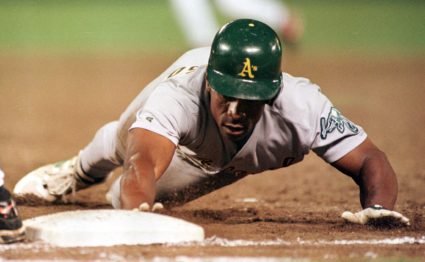 OAKLANDS HENDERSON DIVES BACK TO FIRST BASE.