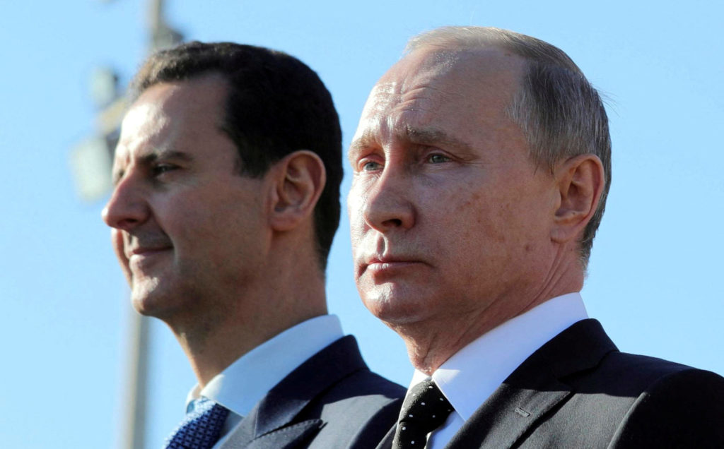 FILE PHOTO: Russian President Putin and Syrian President Bashar al-Assad visit the Hmeymim air base in Latakia Province