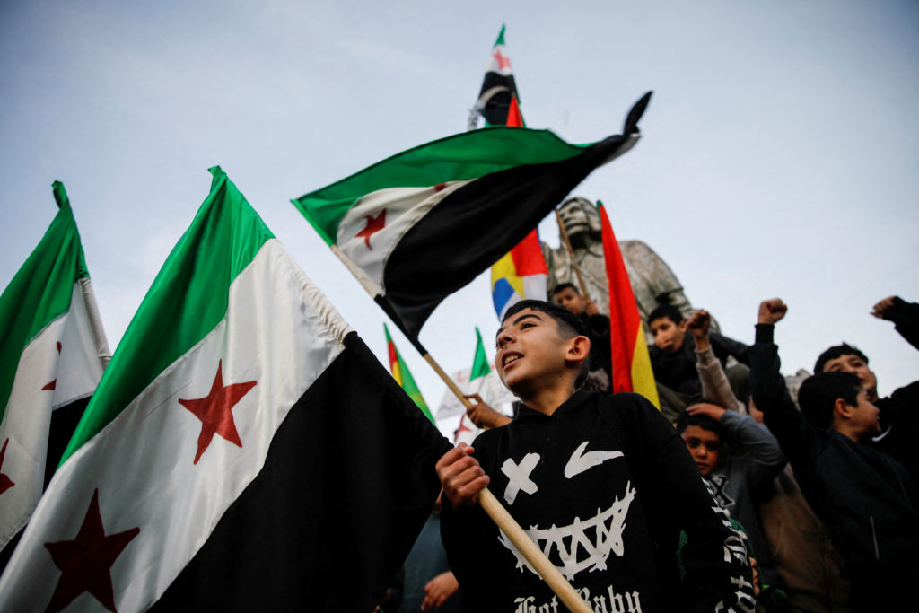 People celebrate after Syrian rebels announced that they had ousted President Bashar al-Assad, in Majdal Shams