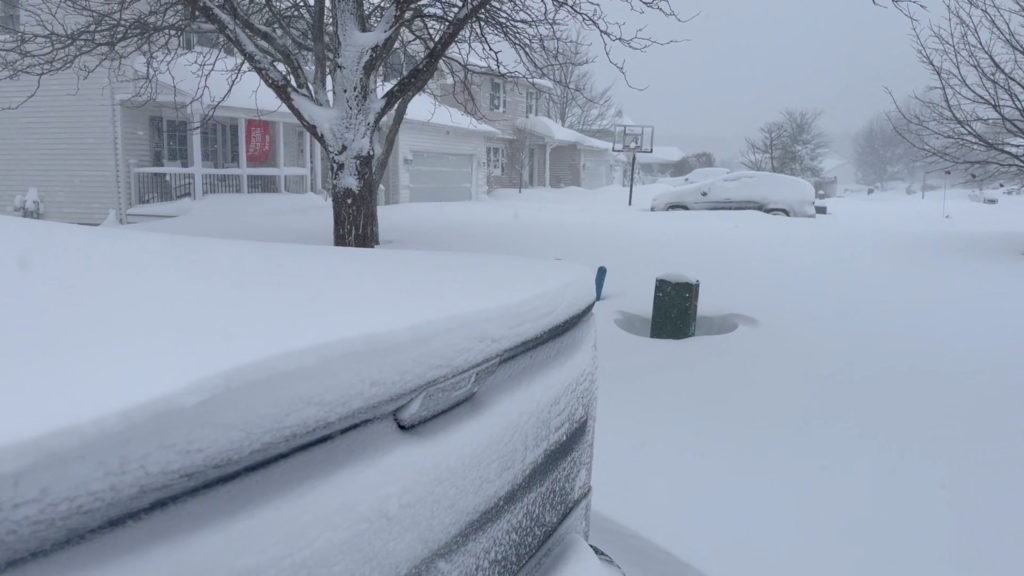 Cars and houses are covered in snow in Lake view