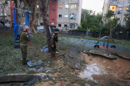Israeli emergency services work at the scene of a missile strike, in Jaffa, south of Tel Aviv