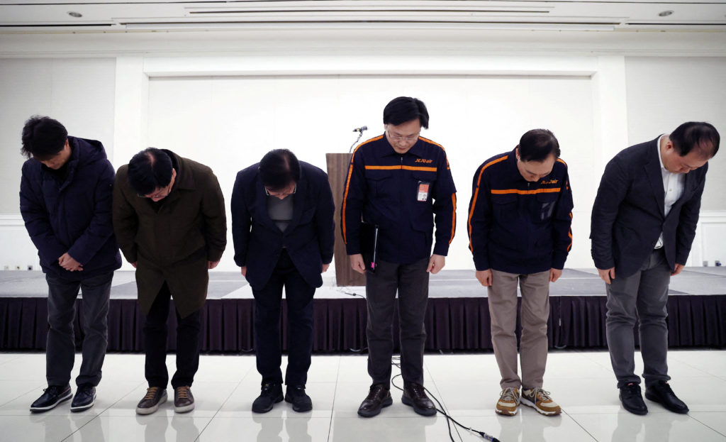 Jeju Air CEO Kim E-bae and officials bow to apologise for their plane’s incident at Muan International Airport as they hol...