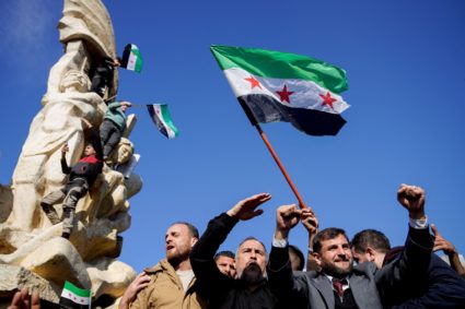 People celebrate after ousting of Syria's Bashar al-Assad, in Aleppo