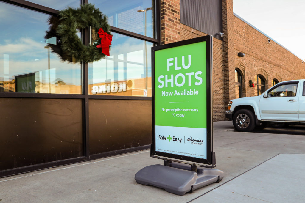 A sign outside of a Wegmans supermarket advertises flu shots
