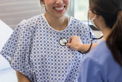 Young adult woman smiles at the cardiologist