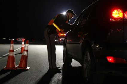 A Jefferson County Sheriff Deputy asks a driver if he has been drinking while smelling for alcohol at a mobile Driving Und...