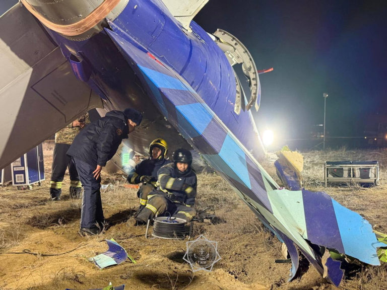 Emergency specialists work at the crash site of a passenger plane near Aktau