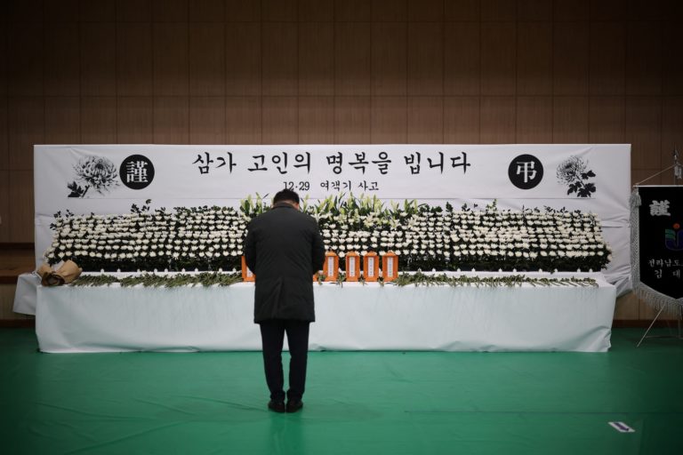 A man mourns at a memorial altar for government officials of Jeollanam-do Office of Education and students who died in the...