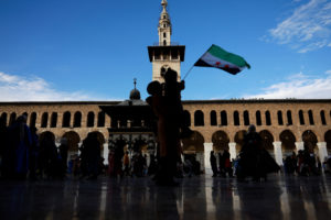 People celebrate, after fighters of the ruling Syrian body ousted Syria's Bashar al-Assad, in Damascus