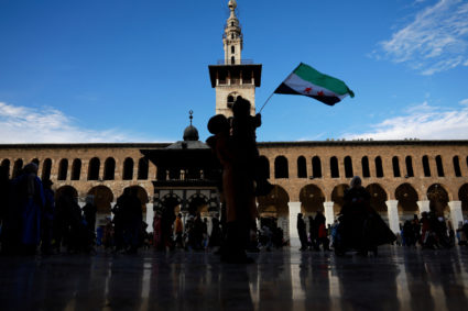People celebrate, after fighters of the ruling Syrian body ousted Syria's Bashar al-Assad, in Damascus