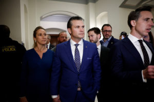 Pete Hegseth, President-elect Donald Trump's choice to be U.S. Defense Secretary walks after a meeting on Capitol Hill in ...