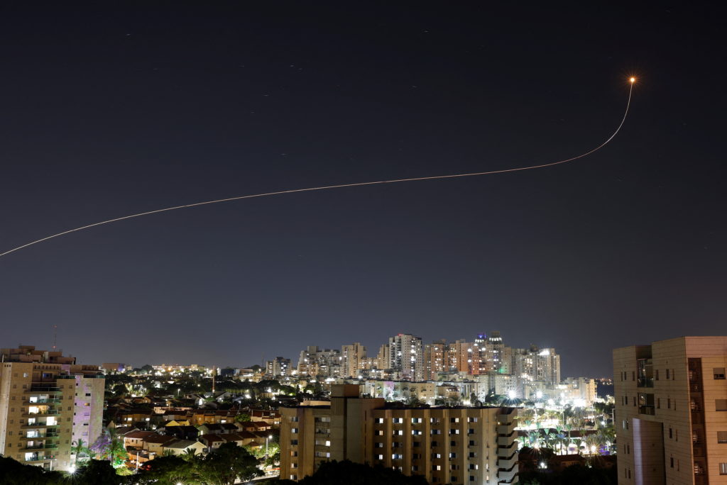 Israel's Iron Dome anti-missile system intercepts a rocket launched from the Gaza Strip towards Israel over the city of As...