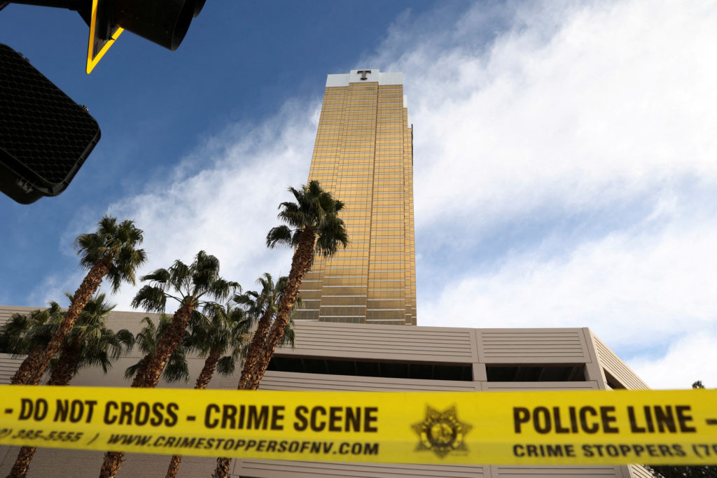 Firefighters work at the Tesla Cybertruck which burned at the entrance of Trump Tower in Las Vegas