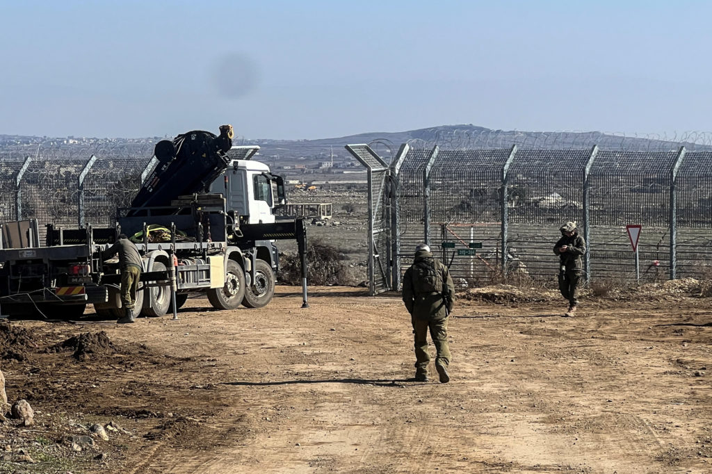 A vehicle used by Israel's military leaves Syria through the ceasefire line with Syria and the Israeli-occupied Golan Heig...