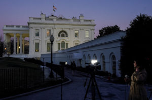A member of the media works outside the White House, in Washington