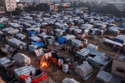 Palestinians dismantle their tent in Deir Al-Balah