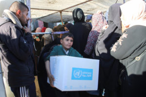 Palestinians receive aid following a ceasefire between Israel and Hamas, in Khan Younis in the southern Gaza Strip