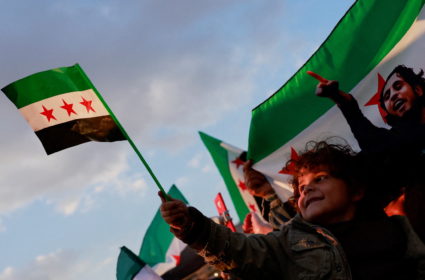 People gather during a celebration called by Hayat Tahrir al-Sham (HTS) after the ousting of Syria's Bashar al-Assad, in D...