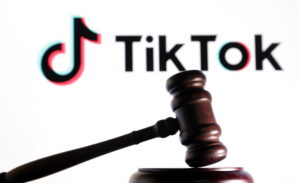 Illustration shows Tik Tok logo and a judge gavel