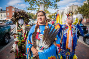 Group of Native Americans dancers belonging to the Lumbee tribe stand in traditional costumes on the streets of Baltimore,...