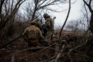Servicemen of the National Guard of Ukraine fire a howitzer towards Russian troops at a position in a front line in Kharki...