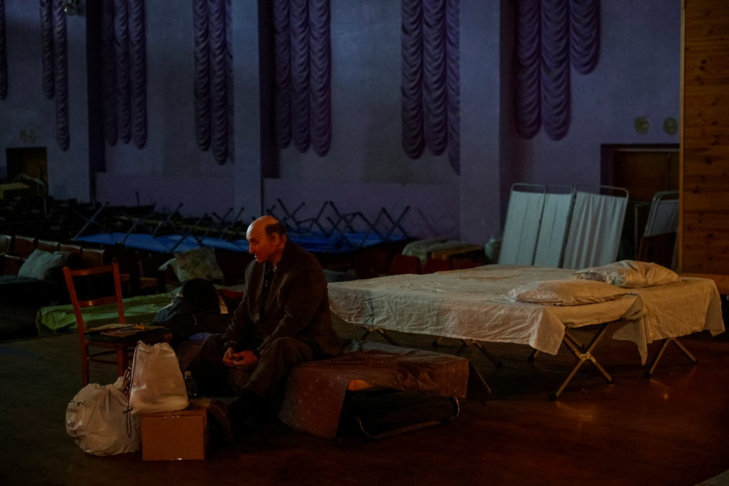 An internally displaced person (IDP) from Donetsk region sits with his stuff in a temporary shelter in the town of Pavlohrad