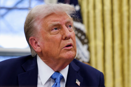 U.S. President Donald Trump signs an executive order in the Oval Office at the White House
