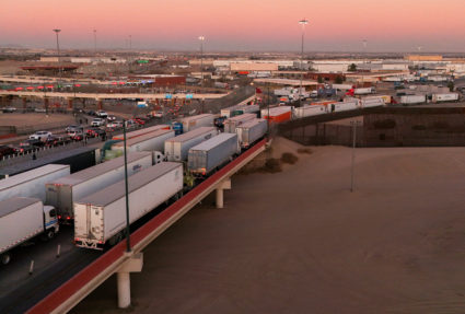 Trucks queue to cross into the United States as new tariffs are expected soon