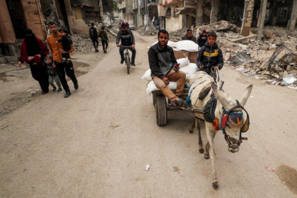 Palestinians wait to receive aid, in Gaza City