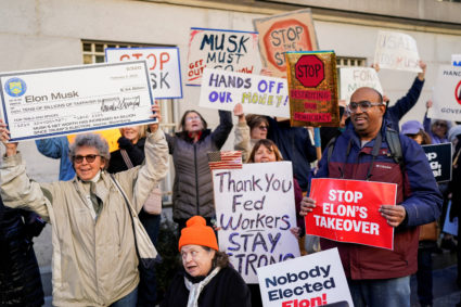 Demonstrators rally outside the Treasury Department after it was reported billionaire Elon Musk has gained access to the U...