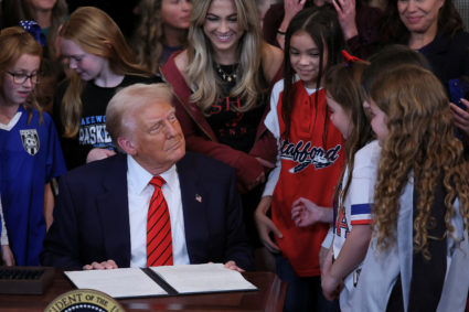 U.S. President Donald Trump signs an executive order banning transgender girls and women from participating in women's spo...