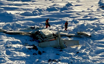 Authorities inspect the wreckage of the Cessna 208B Grand Caravan aircraft operated by Bering Air, near Nome