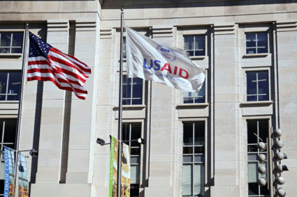 FILE PHOTO: An American flag and USAID flag fly outside the USAID building in Washington
