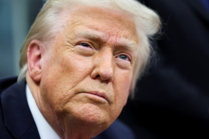 U.S. President Donald Trump signs an executive order in the Oval Office of the White House in Washington