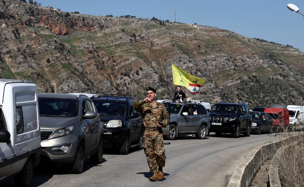 Cars queue as they seek to enter the Lebanese southern village of Kfar Kila, in Deir Mimas