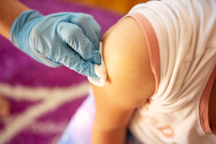 Girl getting a vaccine.