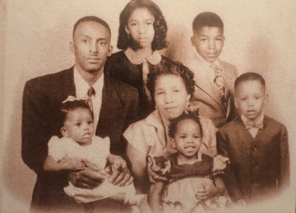 sepia toned historic photo of a Michigan family with two parents and five children