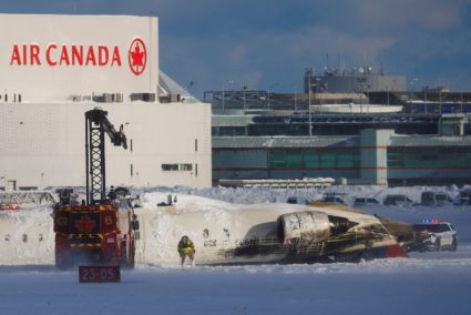 Emergency responders work around an aircraft on a runway, after a plane crash at Toronto Pearson International Airport in ...