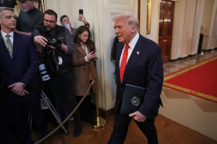 U.S. President Donald Trump signs an executive order banning transgender girls and women from participating in women's spo...