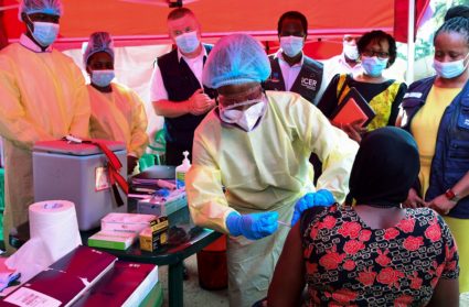 A Ugandan doctor vaccinates the contact of a patient who tested positive during the launch of the vaccination for the Suda...