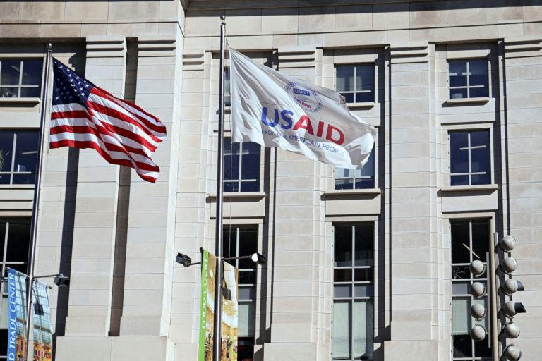 FILE PHOTO: An American flag and USAID flag fly outside the USAID building in Washington
