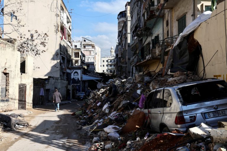 FILE PHOTO: A man walks past a damaged site in the Chiyah district of Beirut's southern suburbs