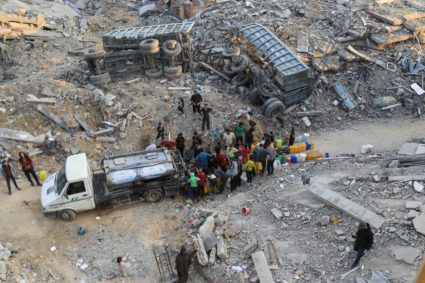 Palestinians fill up containers with water, in Jabalia refugee camp